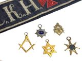 a sash with masonic symbols on it next to other items