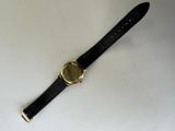 an image of a watch on a white surface with a black strap