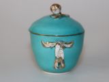 a blue bowl with a cow on it on a white surface