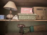 a shelf with boxes and a lamp on top of it