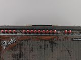 an old fender guitar amplifier sitting on top of a wooden table