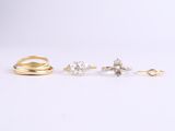 three gold rings and two silver rings on a white background