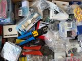 a cardboard box filled with assorted electronics and other items