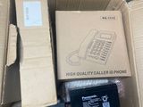 a cardboard box with a phone and other items in it