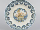 an image of a blue and white plate with a painting on it