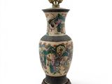 a vase with a bird on it sitting on a table