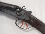an old gun that is on display on a white surface