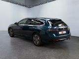 the rear end of a blue car parked in a garage