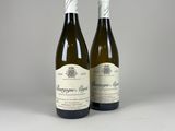 two bottles of wine sitting next to each other on a table