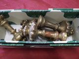 a box with a bunch of brass chess pieces in it
