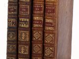 three old books sitting on top of each other on a table