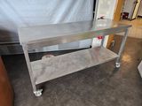 a stainless steel table on wheels in a kitchen
