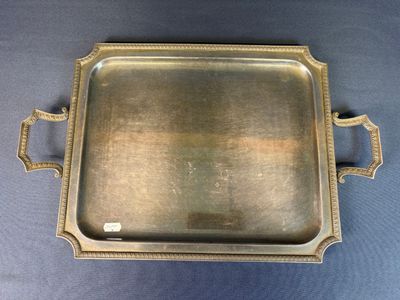 a silver tray with handles and handles on a blue background