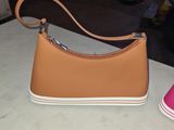 a purse and a pair of shoes sitting on a table
