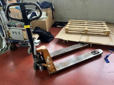 a picture of a room with a pallet and boxes on the floor
