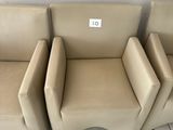 three beige leather chairs sitting on top of a tiled floor