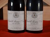 two bottles of wine sitting next to each other on a table
