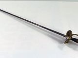 an old sword is laying on top of a white table