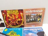 a lot of records on a white table top