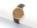 une image d'une montre-bracelet en or avec des chiffres romains sur le cadran