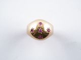 an image of a gold ring with pink stones on a white surface
