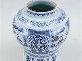 a blue and white vase sitting on a white surface