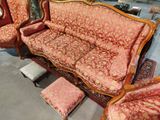 a couch and chairs that are sitting in a room