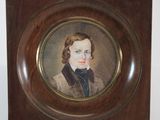 portrait of a young man in a brown coat in a wooden frame