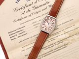 a brown leather strap on the wrist of a watch