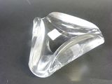 a clear glass object sitting on a black surface