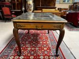 a table with a glass top on a red rug