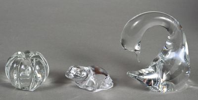 three glass animals sitting next to each other on a table