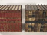 two books are stacked on top of each other on a table