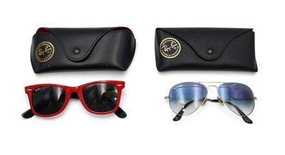 a pair of sunglasses and sunglasses case sitting next to each other