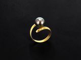 a gold ring with a black pearl on it