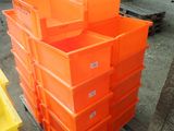 many orange boxes stacked on a pallet in a warehouse