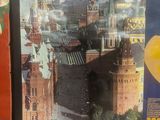three posters on the wall of a building with a view of a city
