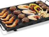 an image of a grill with different types of food on it