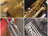 four different pictures of a saxophone, a drum, and a bag of music equipment