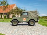 a green military truck parked in front of a house