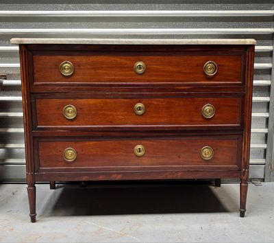 a wooden dresser with brass knobs on it
