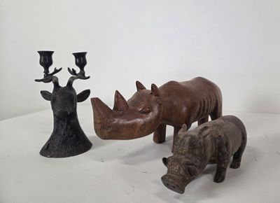 three rhino figurines sitting next to each other on a table