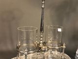 a silver tray with glasses and a bottle on top of it
