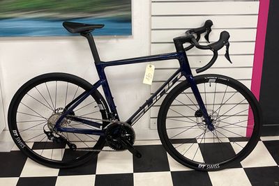 a bike that is parked in front of a wall