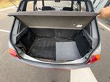 a trunk of a car that is open on the side of the road