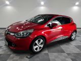 a red car parked in a garage with a checkered floor