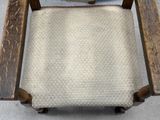 a wooden chair with a cushion on top of it
