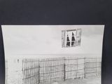 a black and white photo of a fence and a window