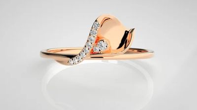 a rose gold ring with diamonds on a white background