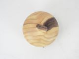 a small wooden object on a white surface